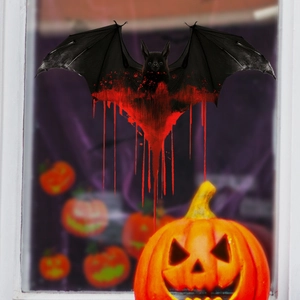 Detail of Halloween window sticker showing a black bat with realistic red blood drip effect