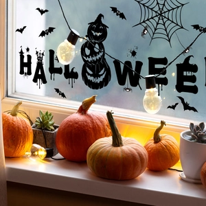 Detail of Halloween silhouette window stickers with pumpkin and bat decals on glass