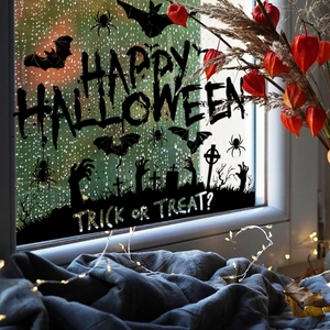 Halloween window stickers with black bats and ghost hand silhouettes on rainy glass
