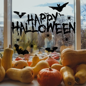 Halloween window decals featuring Happy Halloween text, bats, and spiders on a glass window