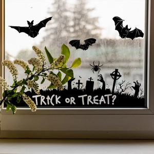 Halloween window decals featuring bats, tombstones and Trick or Treat text on glass