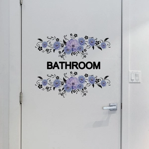 Purple floral vine bathroom wall sticker with bold BATHROOM text on a white door