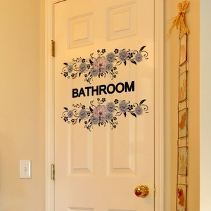Detail of purple floral bathroom door sticker with BATHROOM text on white door