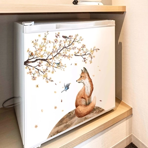 Detailed view of watercolor fox and flower branch sticker on a white refrigerator surface