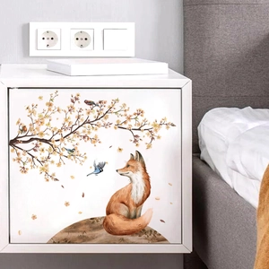 Self-adhesive fox and cherry blossom sticker on a white cabinet for home wall decoration