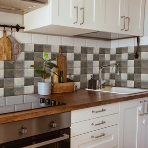 Macro view of vintage gray marble checkerboard tile stickers used as a kitchen backsplash