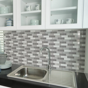 Waterproof grey and white tile stickers applied on a modern kitchen backsplash wall