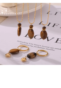 Detail of tiger eye stone jewelry set with 18k gold plating and Lucky charm engraving