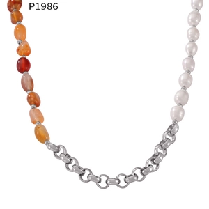 Detail of natural stone and pearl beaded necklace with 18k gold plated steel chain