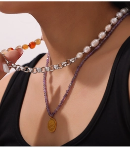 Detail of layered necklace with Good Luck pendant, baroque pearls and natural stones