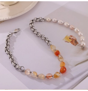 Detail of mixed-media necklace with silver metal links, pearls, and carnelian stones
