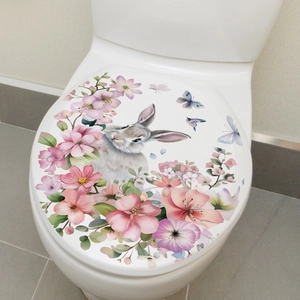 Cartoon rabbit and pink flowers decorative watercolor sticker applied on white toilet lid