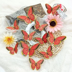 Detailed view of red butterflies with gold edges on lace fabric for wall decoration