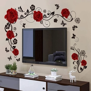 Detail showing red roses and black butterfly wall stickers on a living room TV background