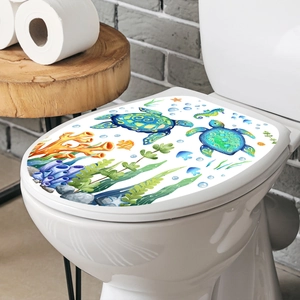 Waterproof sea turtle and coral wall stickers on a white toilet lid in a bathroom