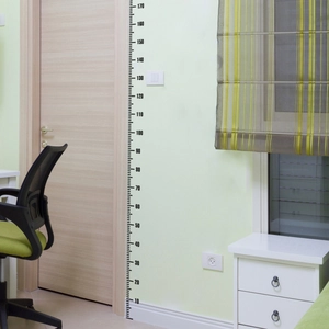 Detail view of a 10-170cm minimalist wall height chart sticker in a home interior setting