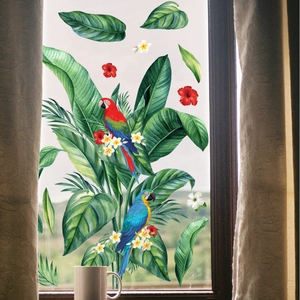 Detail of tropical parrot stickers with green leaves and hibiscus flowers on window glass