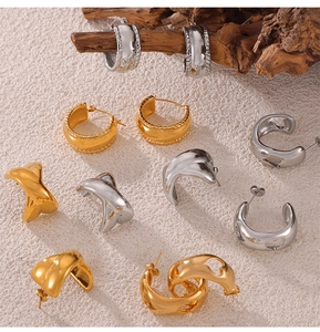 Collection de boucles d'oreilles géométriques dorées et argentées sur un socle d'art