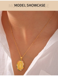 Close-up of a gold oval Virgin Mary pendant necklace with colorful zircon gemstones