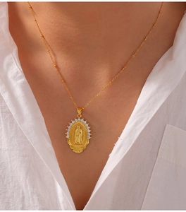 Detail of gold-plated Virgin Mary pendant necklace with white cubic zirconia micro-inlay