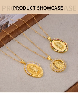 Detail of three gold Virgin Mary pendants with colorful zircons on bead chains