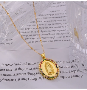 Detail of gold Virgin Mary pendant with multicolored crystals on a beaded chain