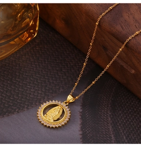Detailed view of Virgin Mary pendant necklace with sparkling cubic zirconia gold plating