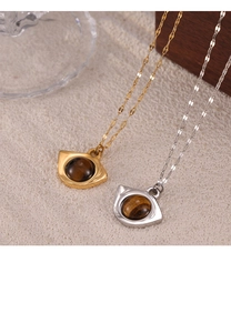 Detail of vintage tiger eye stone pendants with elegant gold and silver metal frames