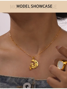 Detail shot of a gold crescent moon and bear pendant necklace with colorful inlay