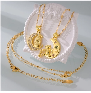 Macro shot of gold moon pendants with Virgin Mary relief and crystal bear charms