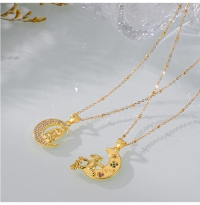 Macro shot of 18K gold plated moon necklaces with bear pendant and CZ stone details