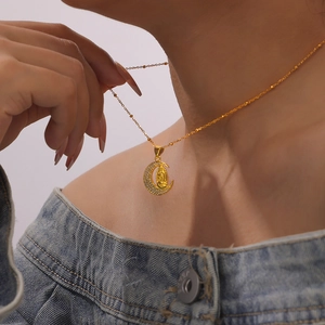 Golden crescent moon necklace with Virgin Mary pendant and sparkling crystals