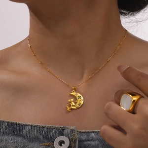 Golden moon and bear pendant necklace with LOVE engraving worn by a model