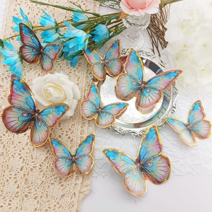 Detailed view of 3D gradient blue and pink butterfly wall stickers with golden edges
