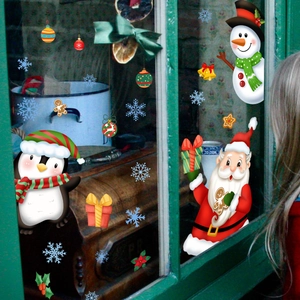 Detailed view of Christmas window stickers featuring Santa Claus, snowman and festive snowflakes