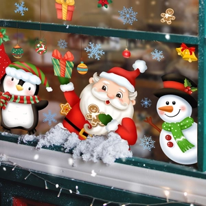 Christmas window stickers featuring Santa Claus and snowman on a green snowy window frame