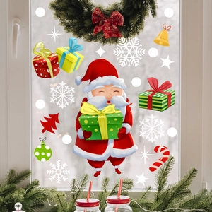 Close-up of festive Christmas window decals featuring Santa Claus and colorful gift boxes