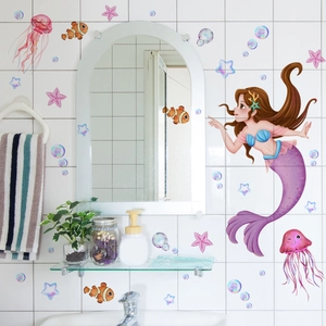 Detail of cartoon mermaid and sea life wall decals on bathroom tiles for nursery decor
