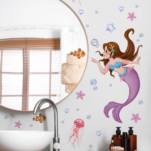 Cartoon mermaid and ocean life wall decals applied to a modern white bathroom wall
