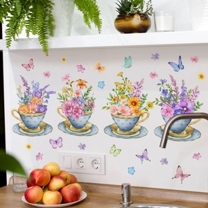 Floral teacup wall stickers with colorful butterflies on a white kitchen backsplash
