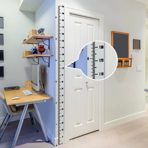 Detail of dual-scale wall growth chart showing 110-130cm markings in a modern home interior
