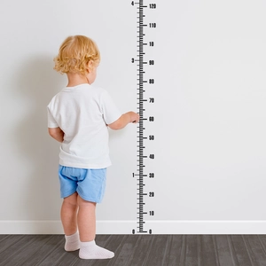 Detail of child using black 0-120cm height growth chart wall sticker on white background