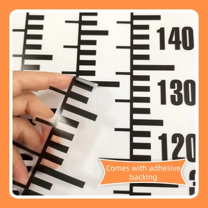Detailed view of black height chart wall sticker showing adhesive backing and clear scales