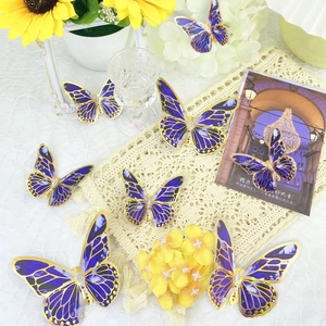 Detail of 3D purple butterflies with gold edges and hollow patterns on lace decor