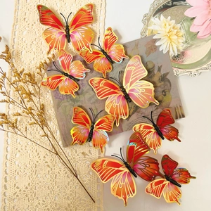 3D orange and gold gradient butterfly wall decals in a decorative lifestyle setting