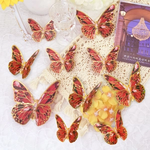 Close-up of red 3D butterfly wall stickers with gold foil hollow patterns and foldable wings