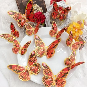 Macro view of 3D red butterflies with gold foil edges on decorative lace and porcelain
