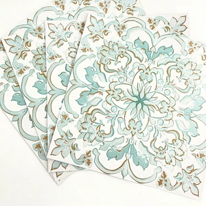 Detail of vintage mandala tile stickers with mint blue and gold symmetrical patterns