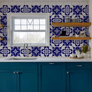 Detail view of vintage dark blue floral tile stickers applied on a kitchen backsplash