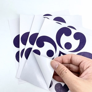 Close-up of vintage purple floral wall tile stickers showing texture and adhesive backing